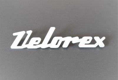 Emblemat VELOREX, plastik, biały