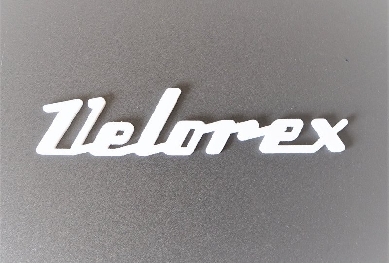 Emblemat VELOREX, plastik, biały-photo1