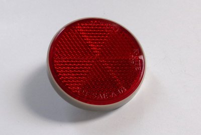 Odblask czerwony, ze śrubką, 59 mm, szara ramka, plastik, Jawa, CZ